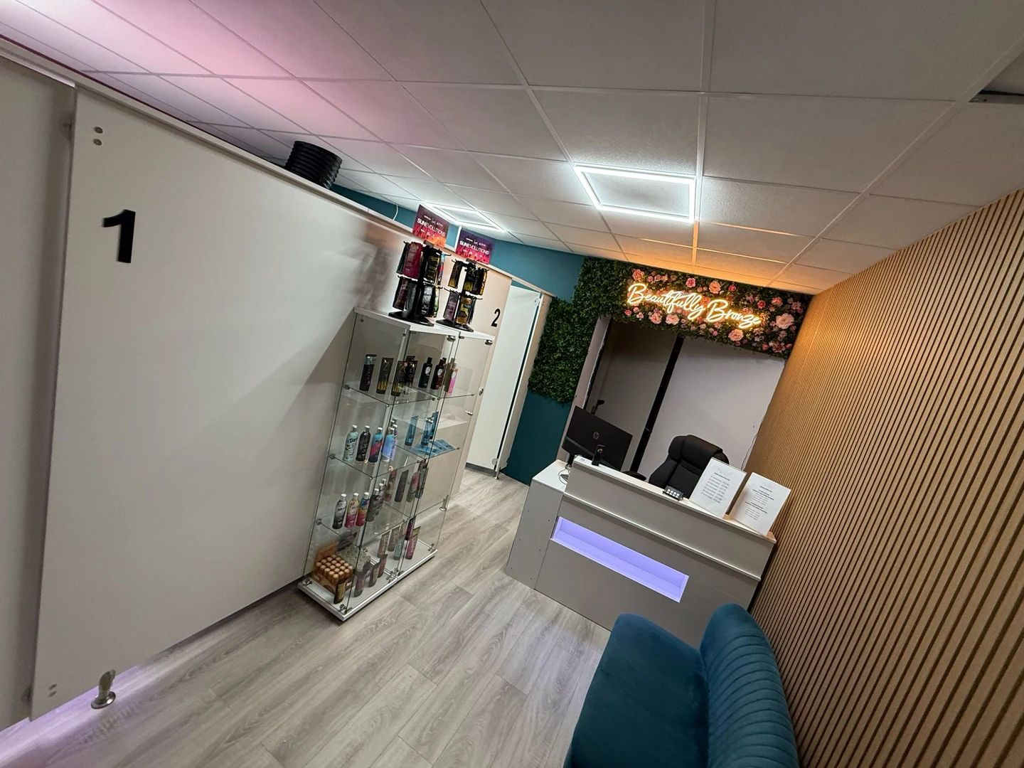 Reception, product display and floral Beautifully Bronze sign inside our Worcester salon